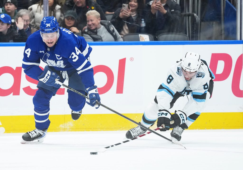 Nov 5, 2025; Toronto, Ontario, CAN; Toronto Maple Leafs center Auston Matthews (34) battles for the puck with Utah Mammoth center Nick Schmaltz (8) during the first period at Scotiabank Arena. Mandatory Credit: Nick Turchiaro-Imagn Images