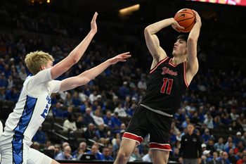 Nov 5, 2025; Omaha, Nebraska, USA;  South Dakota Coyotes guard Jesse McIntosh (11) attempts a shot over Creighton Bluejays forward Jackson McAndrew (23) during the first half at CHI Health Center Omaha. Mandatory Credit: Steven Branscombe-Imagn Images