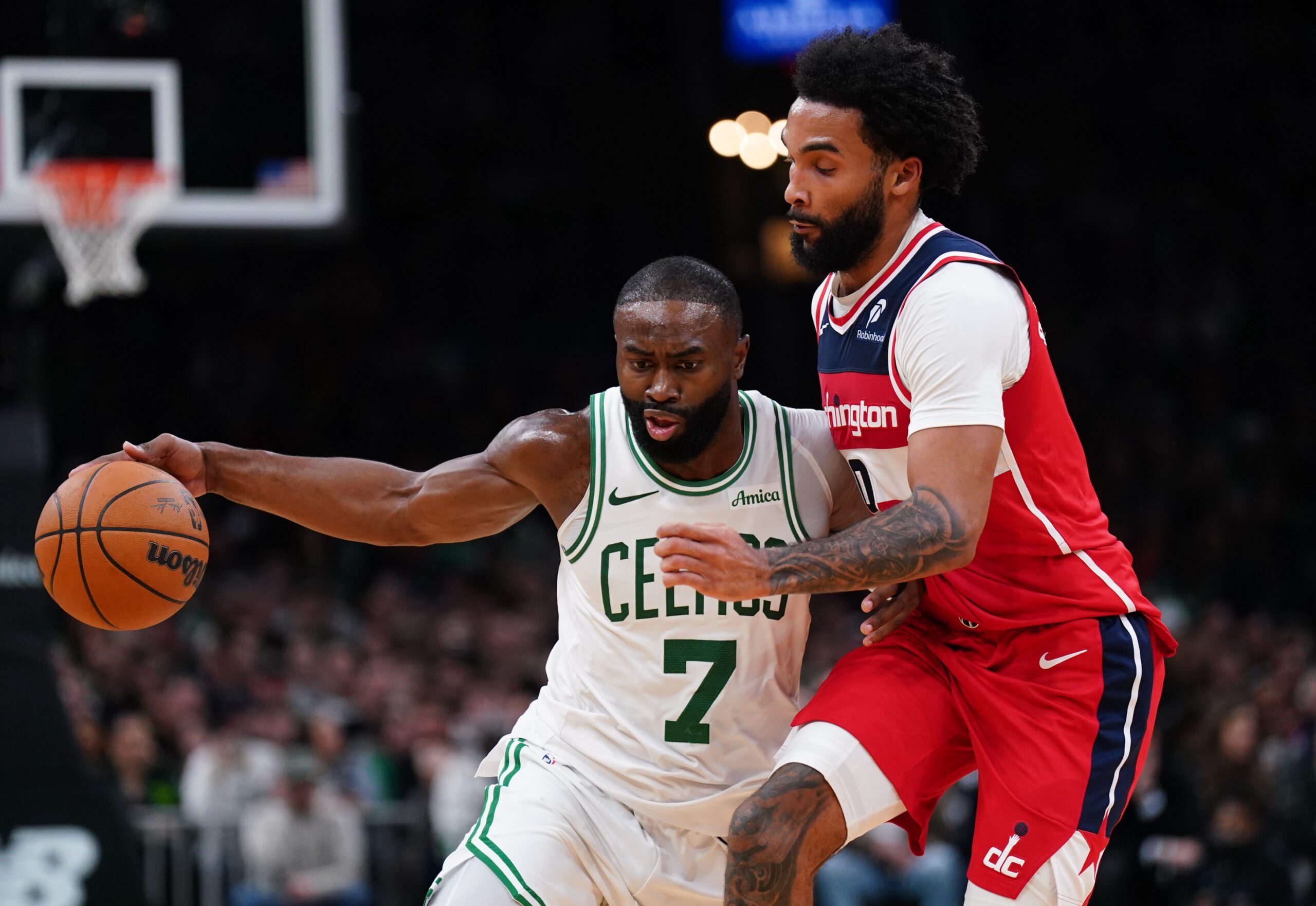 Nov 5, 2025; Boston, Massachusetts, USA; Boston Celtics guard/forward Jaylen Brown (7) drives the ball against Washington Wizards guard/forward Justin Champagnie (9)  in the second half at TD Garden. Mandatory Credit: David Butler II-Imagn Images