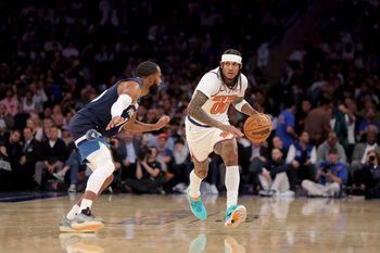 Nov 5, 2025; New York, New York, USA; New York Knicks guard Jordan Clarkson (00) brings the ball up court against Minnesota Timberwolves guard Mike Conley (10) during the fourth quarter at Madison Square Garden. Mandatory Credit: Brad Penner-Imagn Images