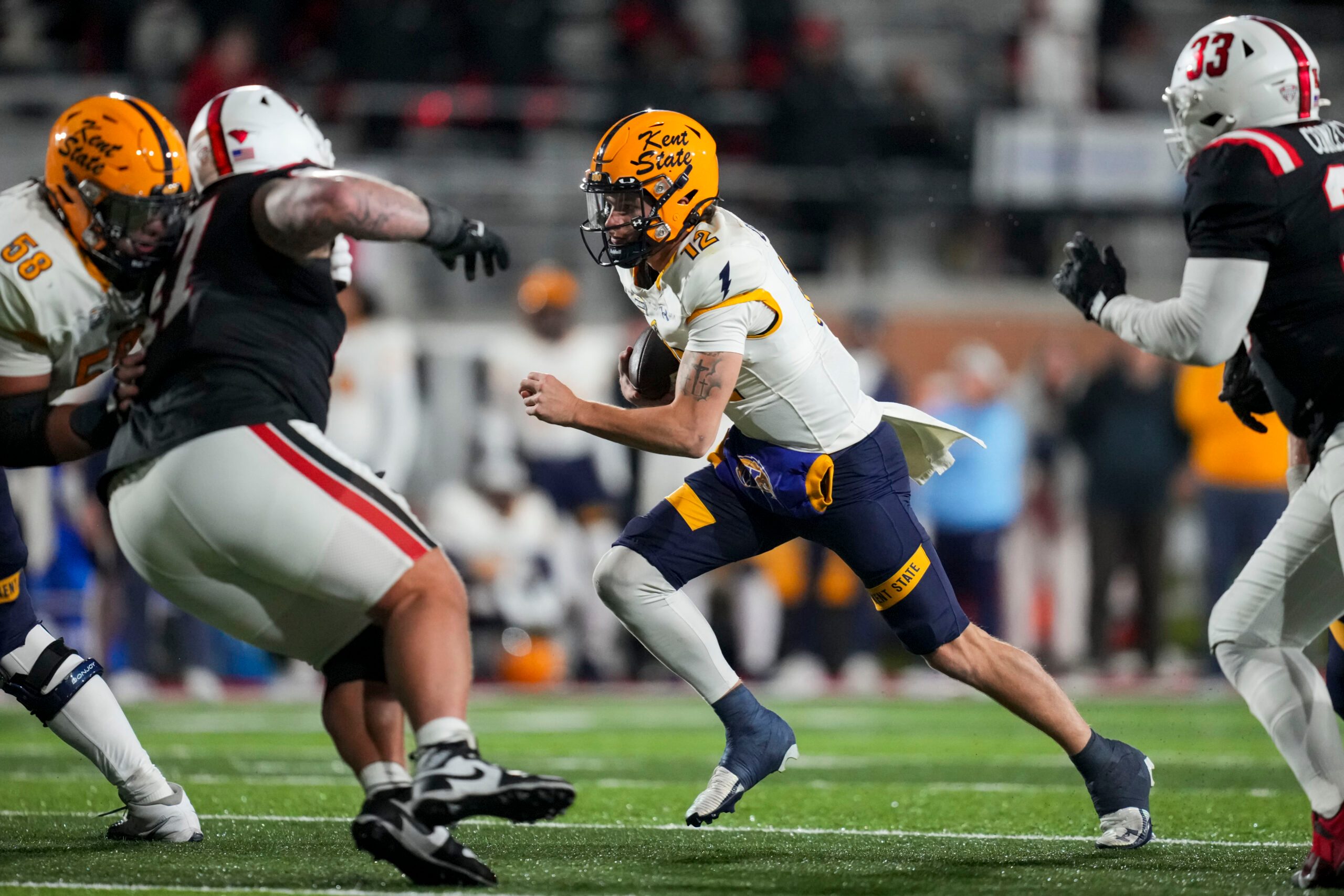 Nov 5, 2025; Muncie, Indiana, USA;  Kent State Golden Flashes quarterback Dru Deshields (12) runs with the ball against the Ball State Cardinals in the second half at Scheumann Stadium. Mandatory Credit: Aaron Doster-Imagn Images