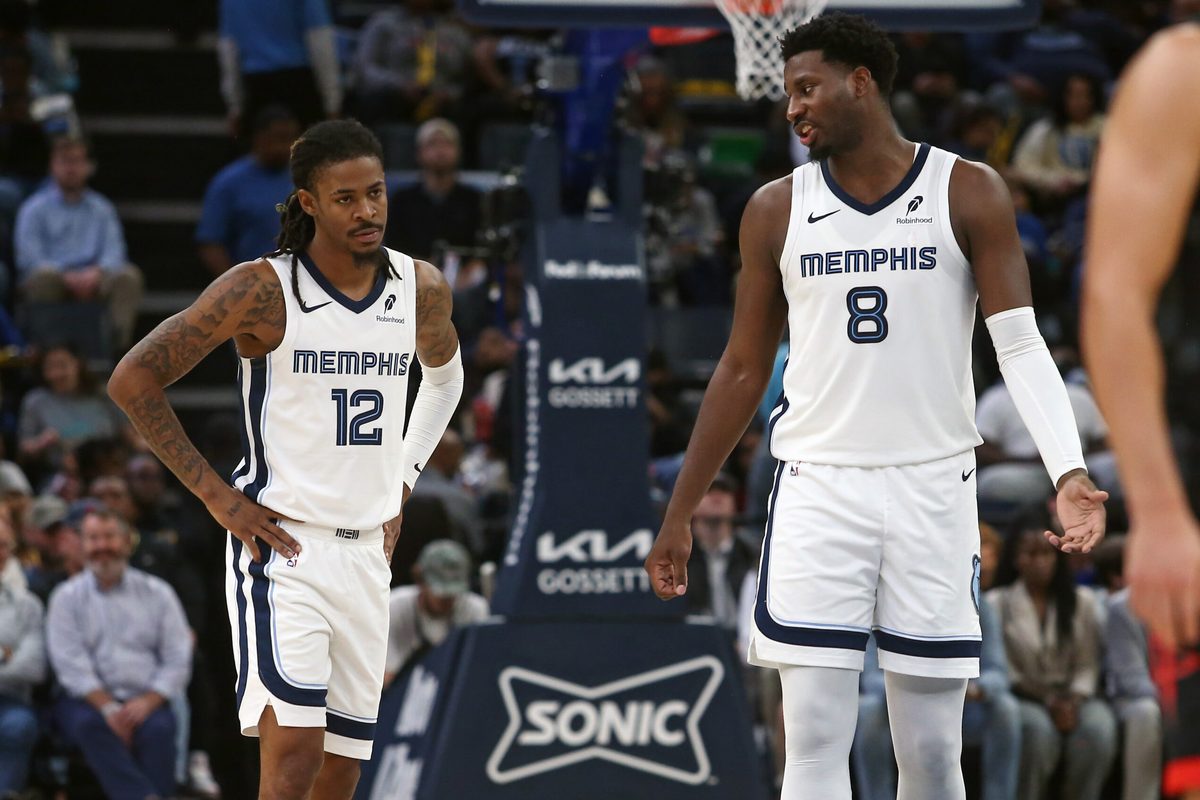 Nov 5, 2025; Memphis, Tennessee, USA; Memphis Grizzlies forward/center Jaren Jackson Jr. (8) talks with guard Ja Morant (12) during the second quarter against the Houston Rockets at FedExForum. Mandatory Credit: Petre Thomas-Imagn Images