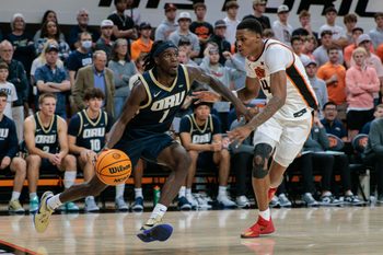 Nov 4, 2025; Stillwater, Oklahoma, USA; Oral Roberts Golden Eagles guard Ty Harper (1) drives to the basket around Oklahoma State Cowboys forward Christian Coleman (4) during the second half at Gallagher-Iba Arena. Mandatory Credit: William Purnell-Imagn Images