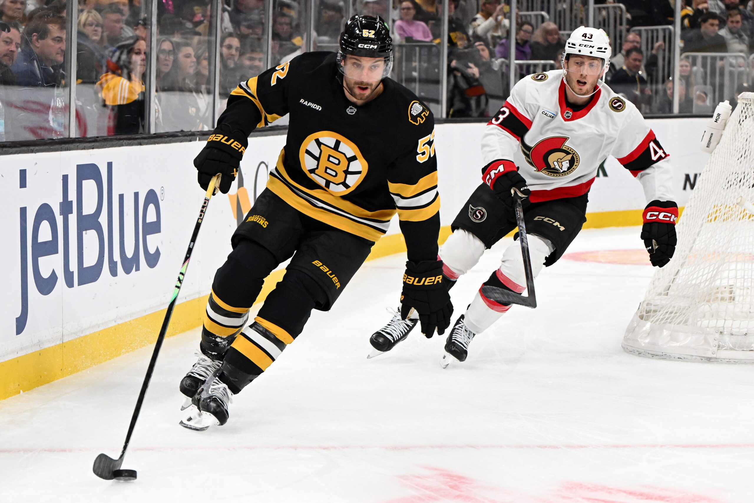 Nov 6, 2025; Boston, Massachusetts, USA; Boston Bruins center Sean Kuraly (52) skates against Ottawa Senators defenseman Tyler Kleven (43) during the first period at the TD Garden. Mandatory Credit: Brian Fluharty-Imagn Images