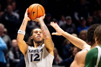 Xavier Musketeers forward Tre Carroll (12) hits a 3-point shot in the first half of the NCAA game against the Le Moyne Dolphins at the Cintas Center in Cincinnati on Nov. 6, 2025.
