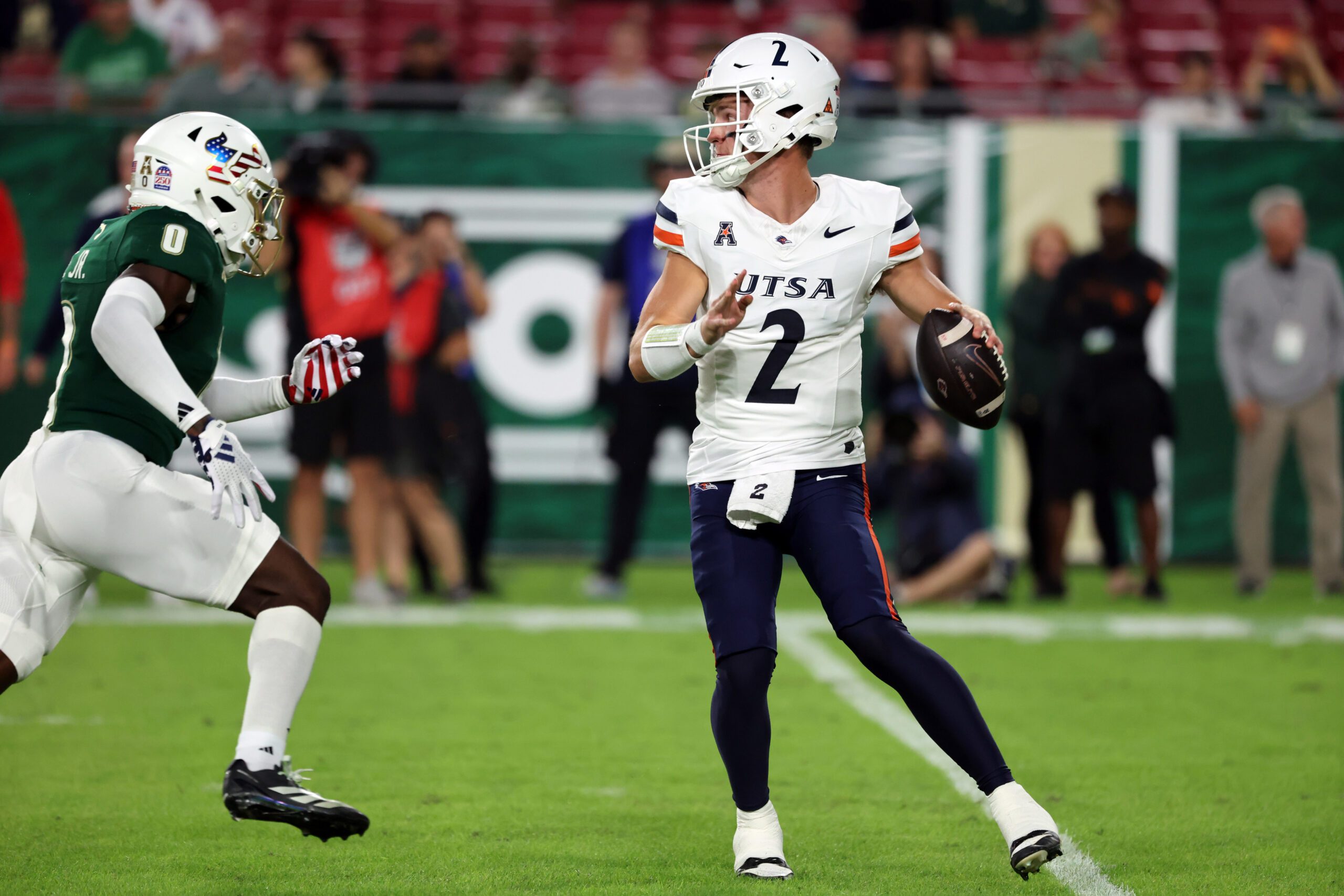 Nov 6, 2025; Tampa, Florida, USA; UTSA Roadrunners quarterback Owen McCown (2) throws the ball as South Florida Bulls cornerback Jarvis Lee (0) pressures during the first half at Raymond James Stadium. Mandatory Credit: Kim Klement Neitzel-Imagn Images