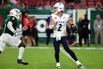 Nov 6, 2025; Tampa, Florida, USA; UTSA Roadrunners quarterback Owen McCown (2) throws the ball as South Florida Bulls cornerback Jarvis Lee (0) pressures during the first half at Raymond James Stadium. Mandatory Credit: Kim Klement Neitzel-Imagn Images