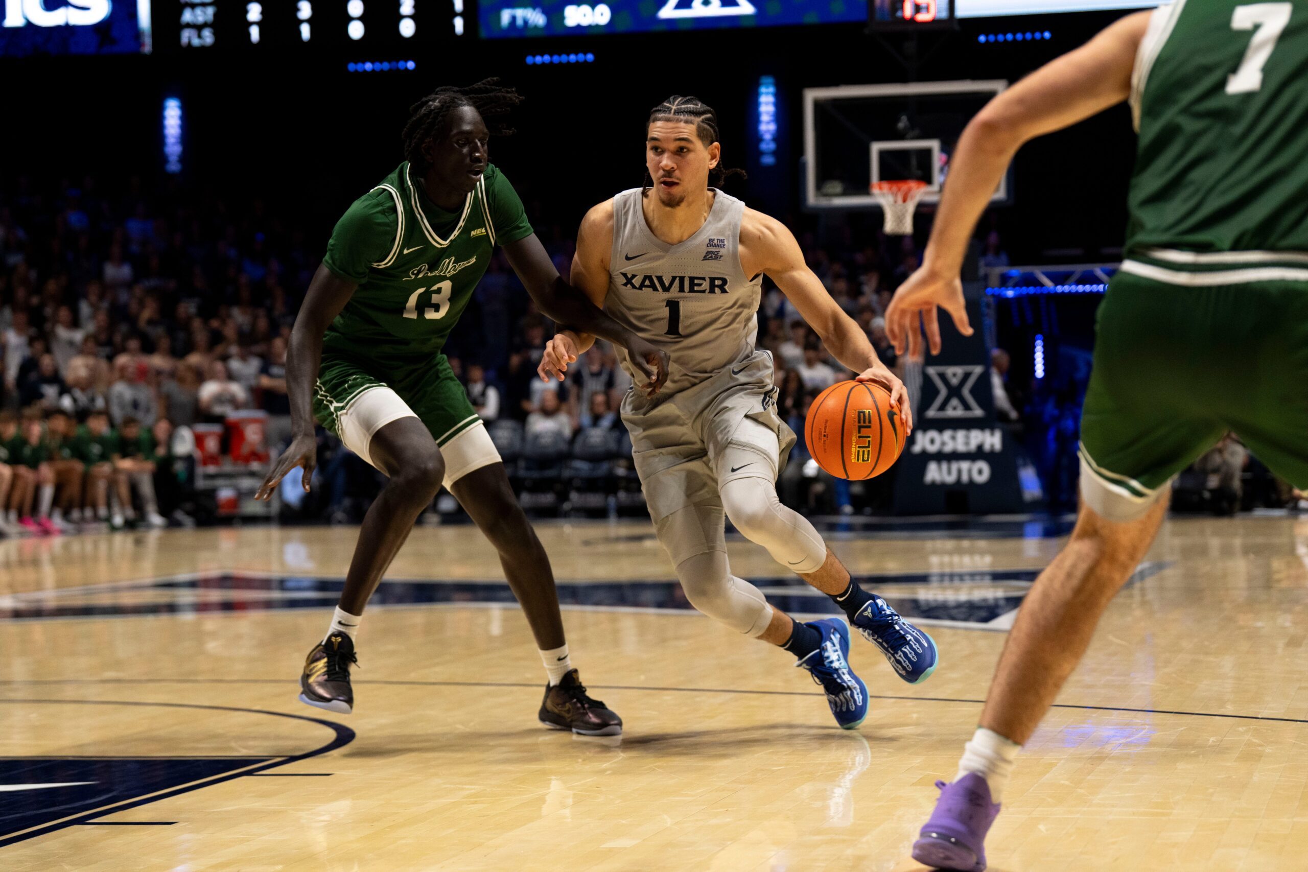 Xavier Musketeers guard Malik Messina-Moore (1) drives on Le Moyne Dolphins guard Deng Garang (13) in the second half of the NCAA game at the Cintas Center in Cincinnati on Nov. 6, 2025.