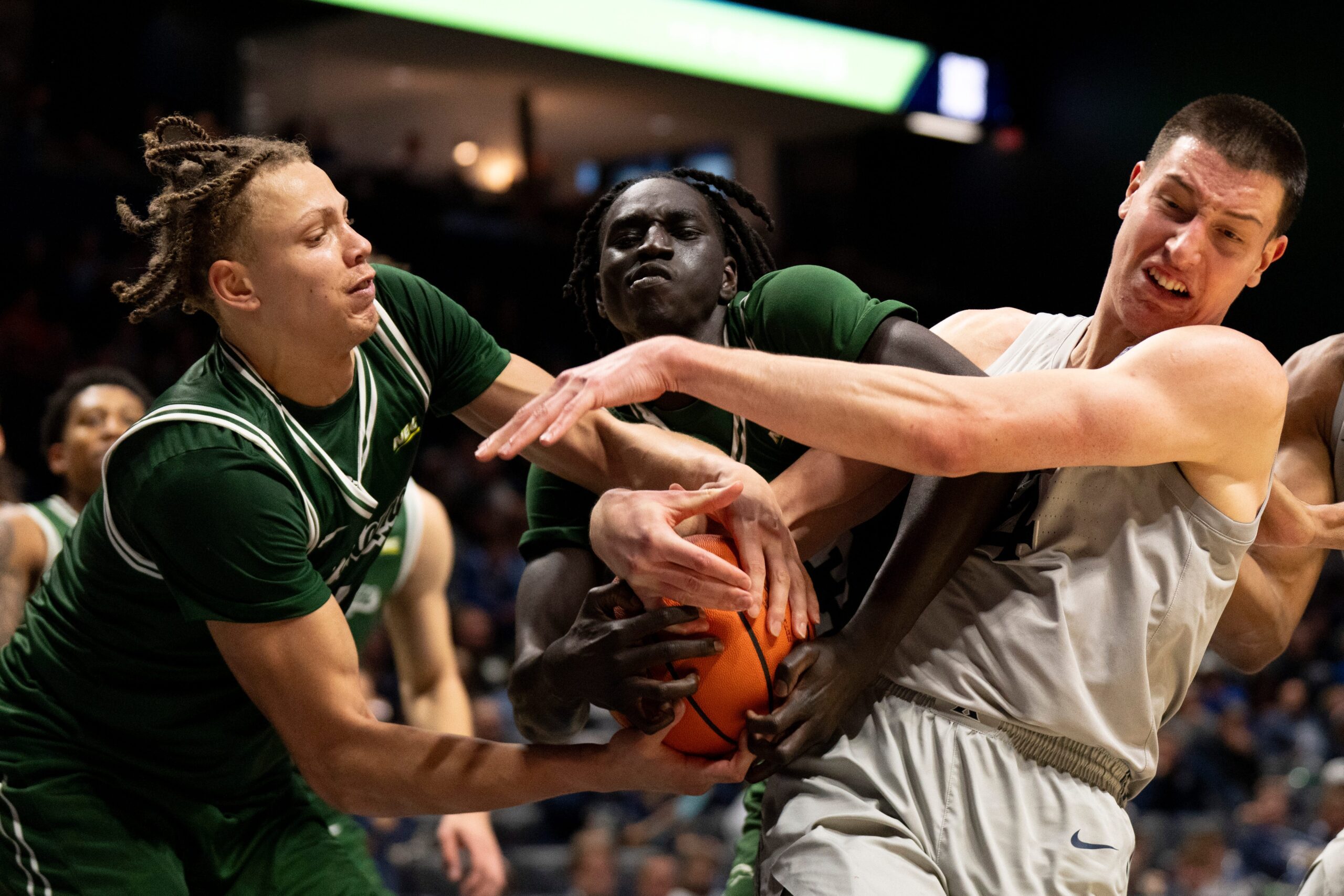 Xavier Musketeers forward Filip Borovicanin (4) fights for a rebound with Le Moyne Dolphins forward Shilo Jackson (4) and Le Moyne Dolphins guard Deng Garang (13) for a jump ball in the second half of the NCAA game at the Cintas Center in Cincinnati on Nov. 6, 2025.