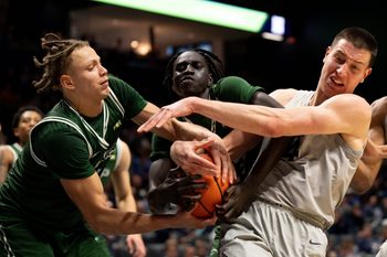 Xavier Musketeers forward Filip Borovicanin (4) fights for a rebound with Le Moyne Dolphins forward Shilo Jackson (4) and Le Moyne Dolphins guard Deng Garang (13) for a jump ball in the second half of the NCAA game at the Cintas Center in Cincinnati on Nov. 6, 2025.