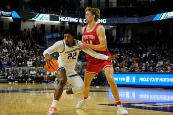 Nov 7, 2025; Evanston, Illinois, USA; Boston University Terriers forward Ben Defty (14) defends Northwestern Wildcats forward Arrinten Page (22) during the first half at Welsh-Ryan Arena. Mandatory Credit: David Banks-Imagn Images