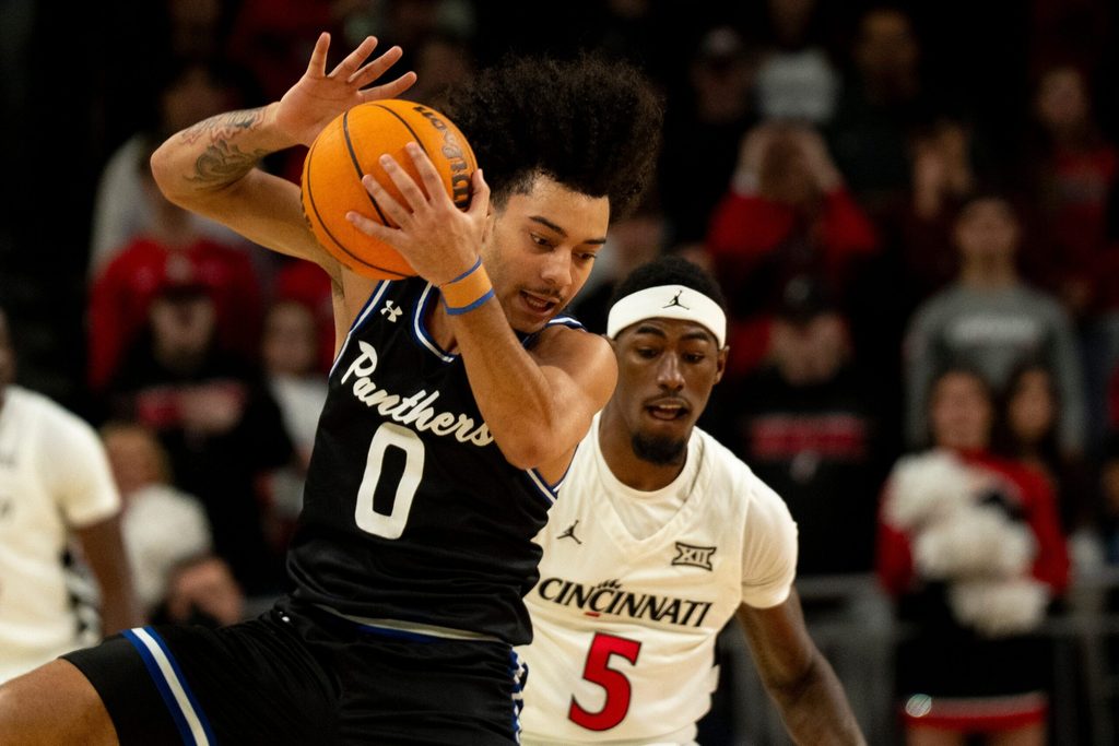 Georgia State Panthers guard Micah Tucker (0) catches a pass as Cincinnati Bearcats guard Sencire Harris (5) guards him in the first half of the NCAA basketball game at Fifth Third Arena in Cincinnati on Nov. 7, 2025.