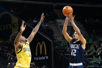Rice’s Trae Broadnax, right, shoots over Oregon’s Takai Simpkins during the first half at Matthew Knight Arena in Eugene Nov. 7, 2025.