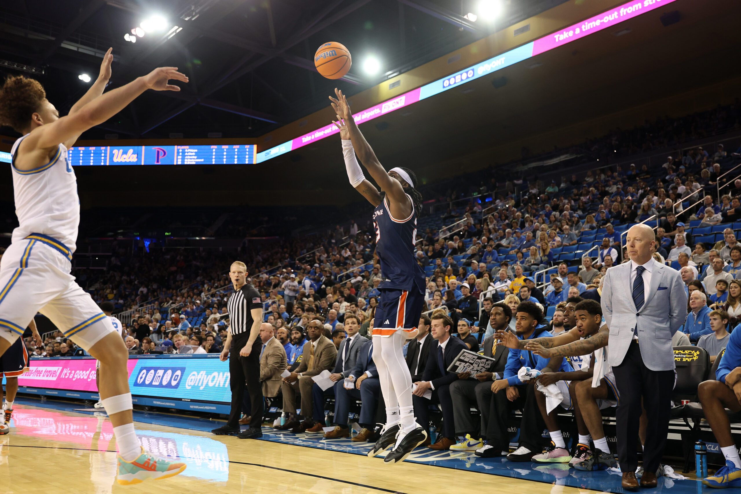 Nov 7, 2025; Los Angeles, California, USA;  Pepperdine Waves forward Javon Cooley (23) shoots three point basket during the first half against the UCLA Bruins at Pauley Pavilion presented by Wescom Financial. Mandatory Credit: Kiyoshi Mio-Imagn Images