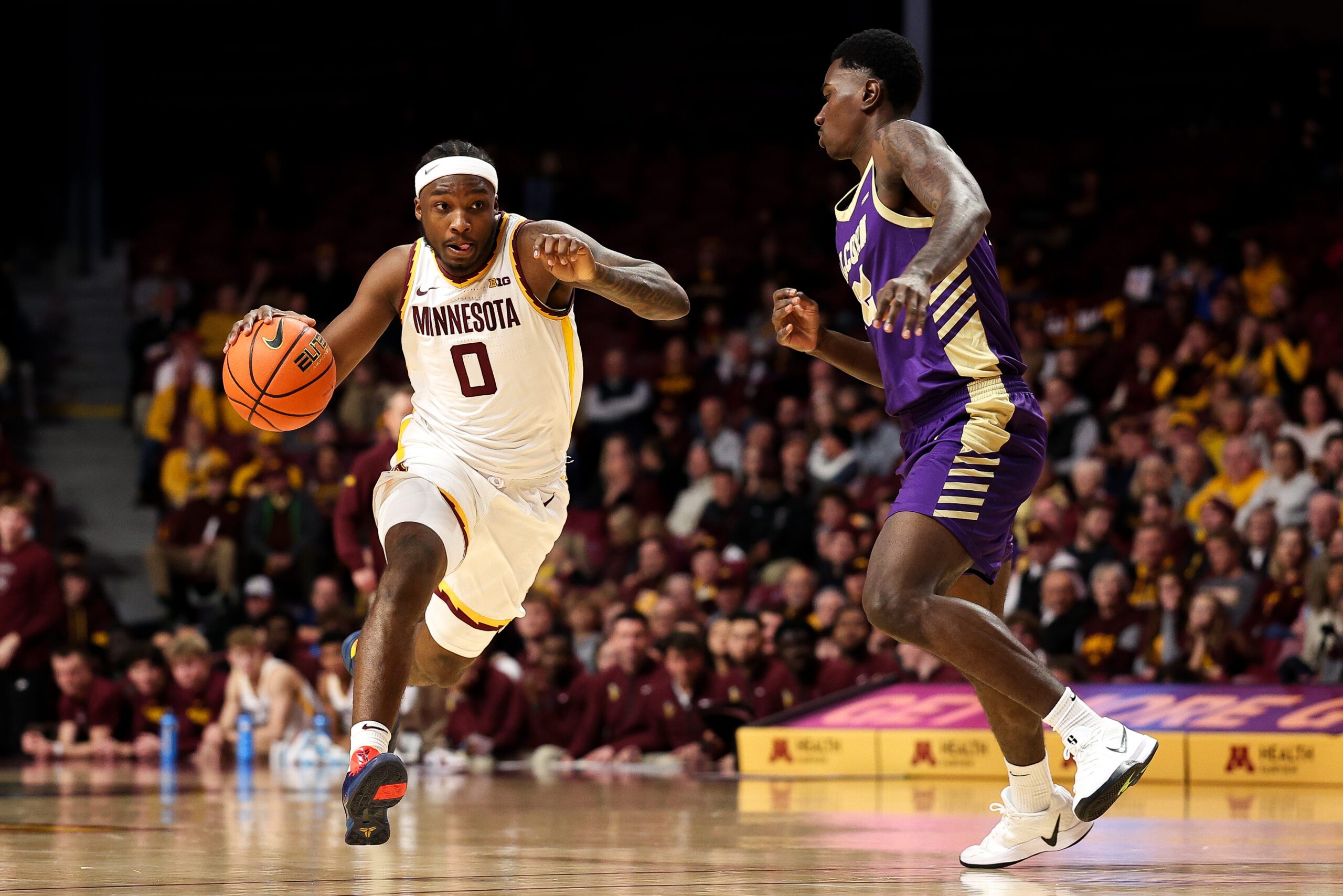 Nov 8, 2025; Minneapolis, Minnesota, USA; Minnesota Golden Gophers guard Chansey Willis Jr. (0) drives towards the basket as Alcorn State Braves guard Mike Jones (22) defends during the first half at Williams Arena. Mandatory Credit: Matt Krohn-Imagn Images