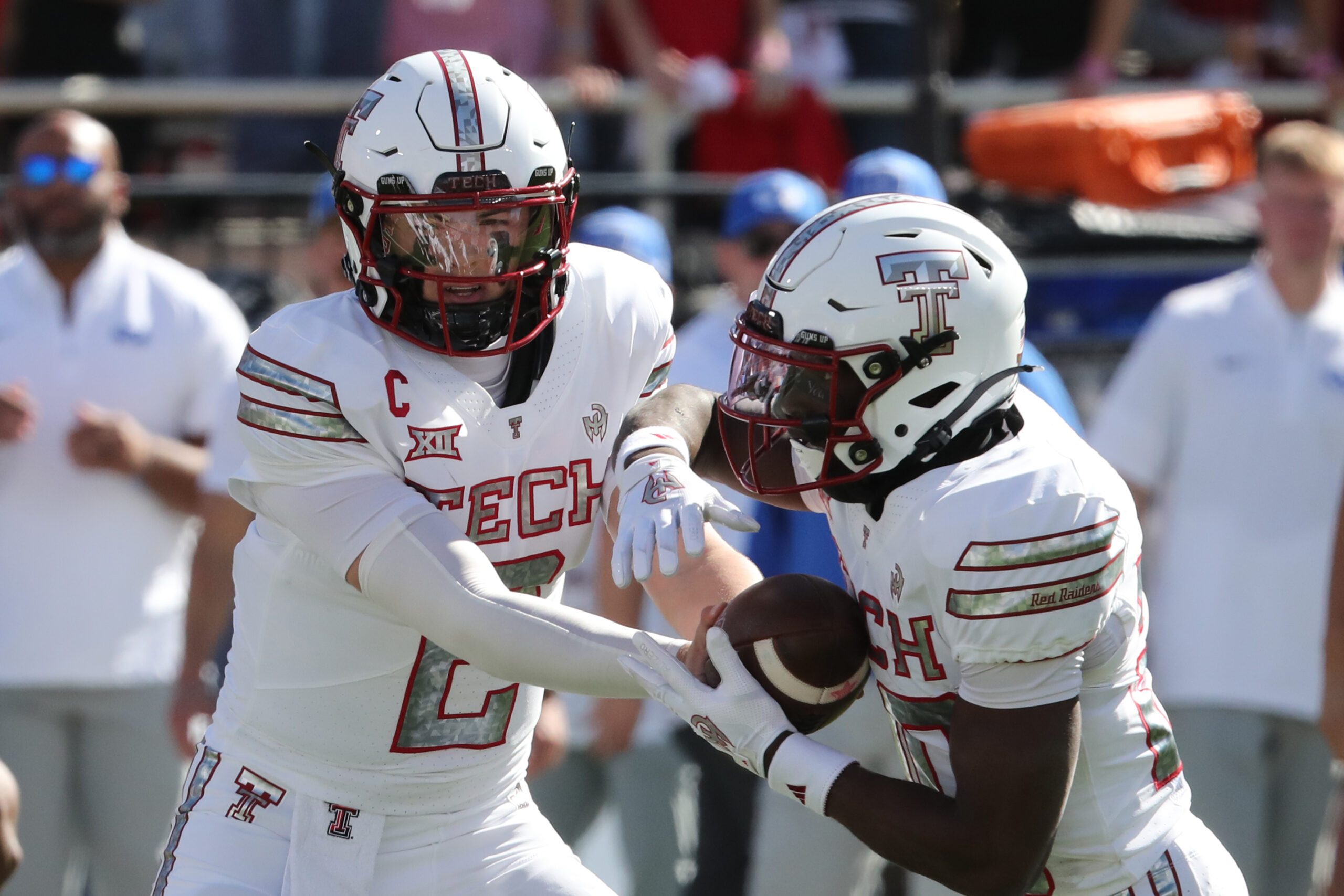 Nov 8, 2025; Lubbock, Texas, USA;  Texas Tech Red Raiders quarterback Behren Morton (2) hands the ball to running back J’Koby Williams (20) in the first half Brigham Young Cougars at Jones AT&T Stadium. Mandatory Credit: Michael C. Johnson-Imagn Images