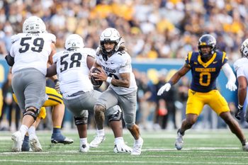 Nov 8, 2025; Morgantown, West Virginia, USA; Colorado Buffaloes quarterback Julian Lewis (10) runs out of the pocket during the third quarter against the West Virginia Mountaineers at Milan Puskar Stadium. Mandatory Credit: Ben Queen-Imagn Images