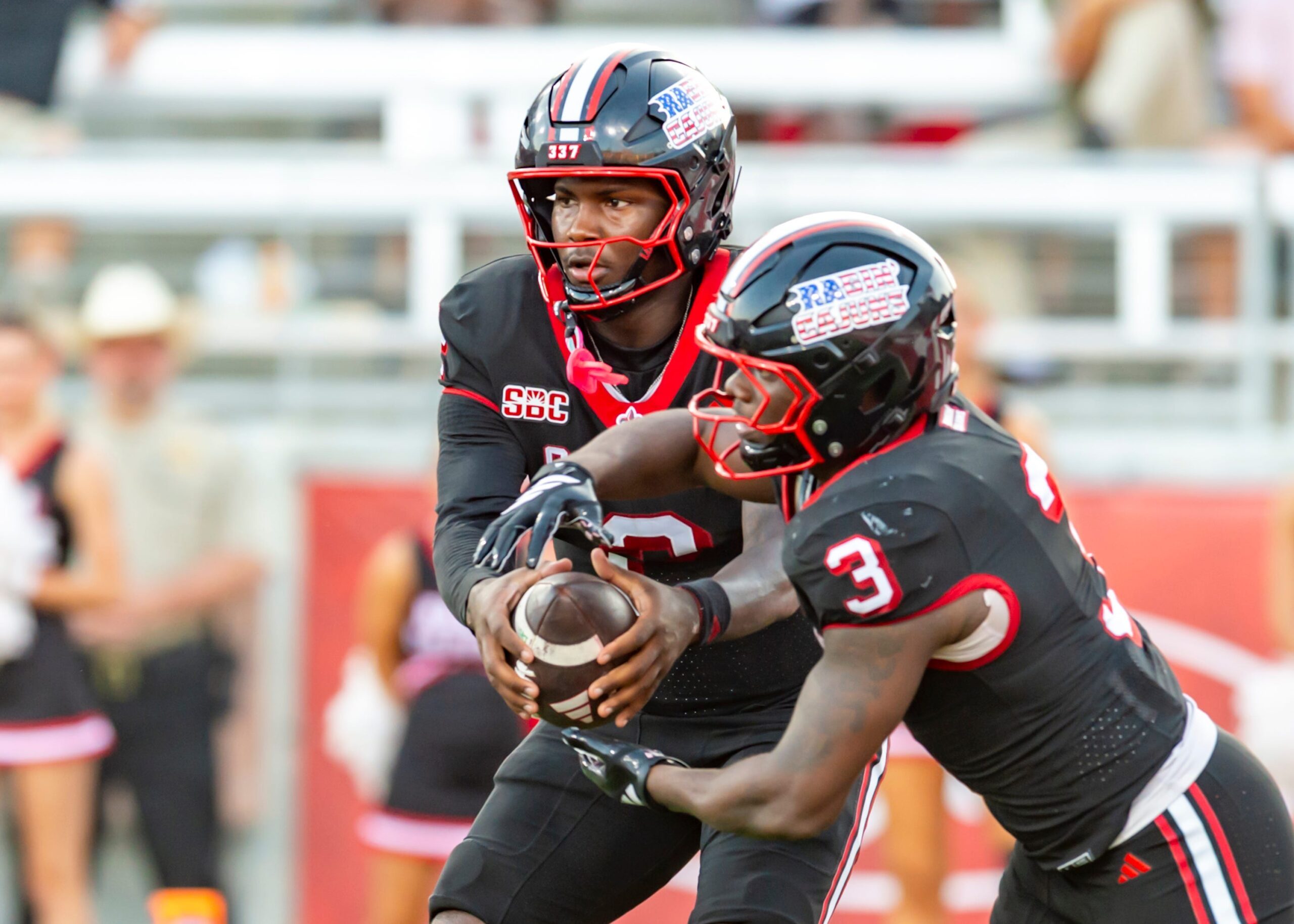 Cajuns quarterback Lunch Winfield 2 hands off to Zylan Perry 3, Louisianas Ragin Cajuns take on Texas State Football. Saturday, Nov. 8, 2025.