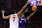 Nov 8, 2025; Salt Lake City, Utah, USA; Weber State Wildcats forward Nigel Burris (5) lays the ball up against Utah Utes forward Josh Hayes (7) during the first half at Jon M. Huntsman Center. Mandatory Credit: Rob Gray-Imagn Images