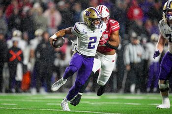 Nov 8, 2025; Madison, Wisconsin, USA;  Washington Huskies quarterback Demond Williams Jr. (2) scrambles under pressure from Wisconsin Badgers linebacker Sebastian Cheeks (15) during the third quarter at Camp Randall Stadium. Mandatory Credit: Jeff Hanisch-Imagn Images