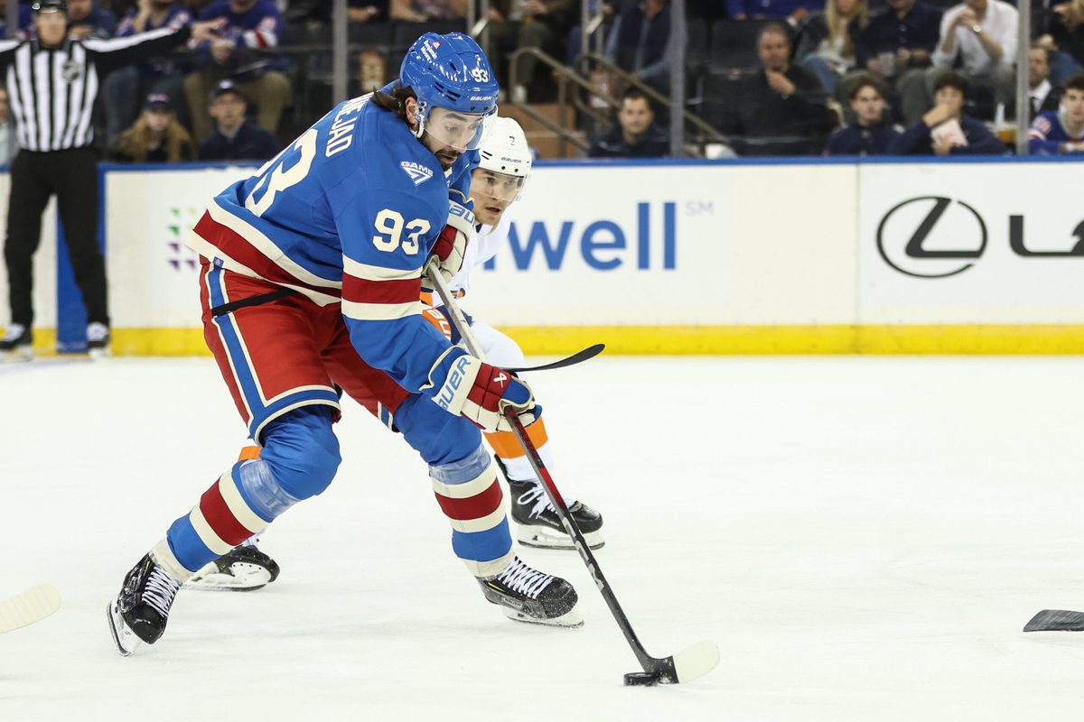 Nov 8, 2025; New York, New York, USA; New York Rangers center Mika Zibanejad (93) and New York Islanders right wing Maxim Tsyplakov (7) battle for control of the puck in the first period at Madison Square Garden. Mandatory Credit: Wendell Cruz-Imagn Images