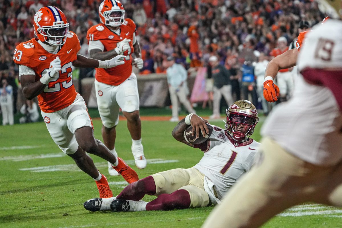 Nov 8, 2025; Clemson, South Carolina, USA; Florida State Seminoles quarterback Tommy Castellanos (1) slides near Clemson Tigers cornerback Ashton Hampton (23) during the second quarter at Memorial Stadium. Mandatory Credit: Ken Ruinard - GREENVILLE NEWS-USA TODAY Network via Imagn Images
