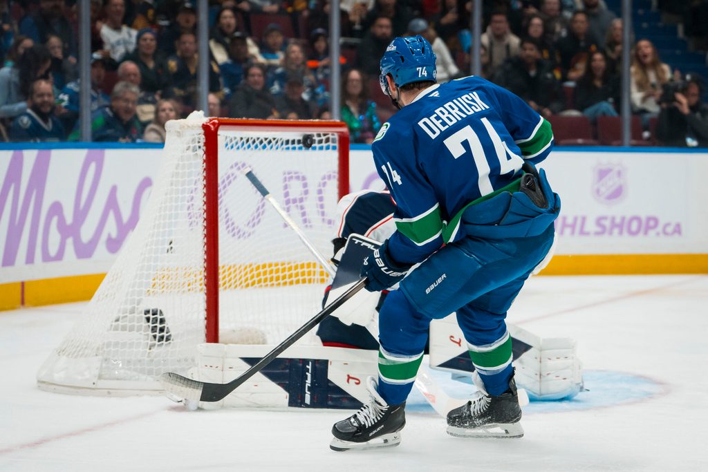 Nov 8, 2025; Vancouver, British Columbia, CAN; Vancouver Canucks forward Jake DeBrusk (74) scores on Columbus Blue Jackets goalie Elvis Merzlikins (90) in the second period at Rogers Arena. Mandatory Credit: Bob Frid-Imagn Images