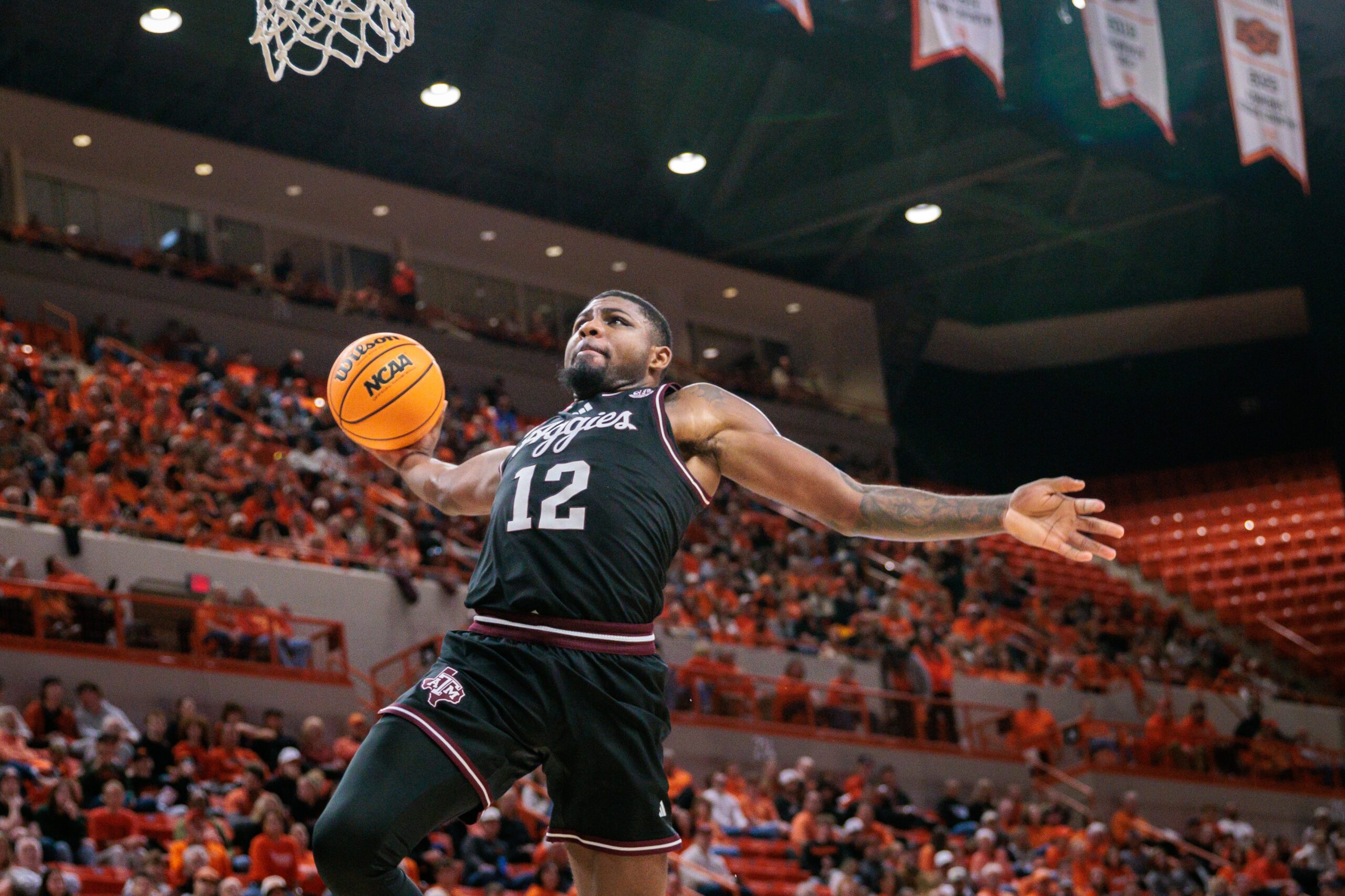 Nov 9, 2025; Stillwater, Oklahoma, USA; Texas A&M Aggies forward Rashaun Agee (12) dunks during the second half against the Oklahoma State Cowboys at Gallagher-Iba Arena. Mandatory Credit: William Purnell-Imagn Images