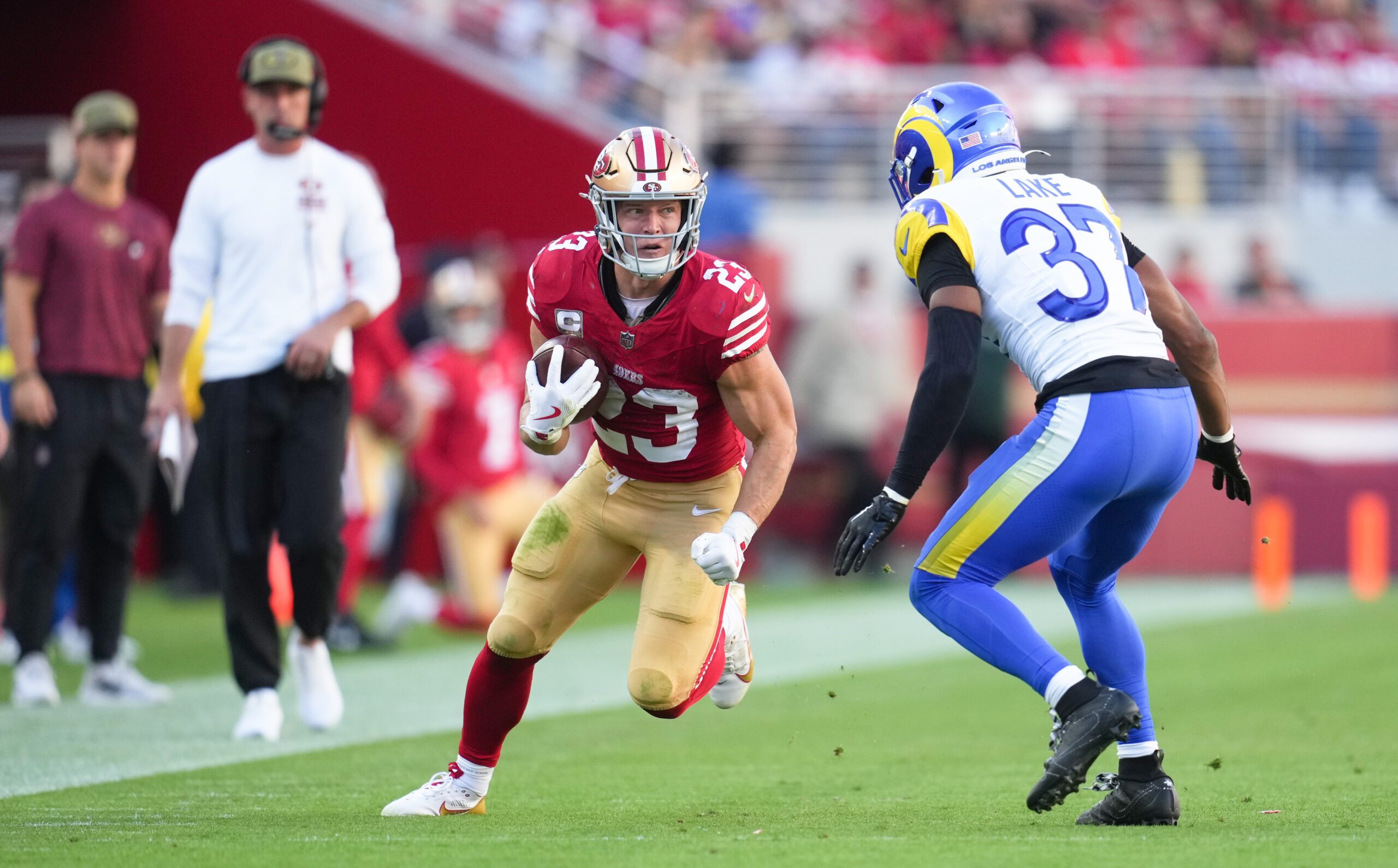 Nov 9, 2025; Santa Clara, California, USA; San Francisco 49ers running back Christian McCaffrey (23) runs the ball against Los Angeles Rams safety Quentin Lake (37) during the second quarter at Levi's Stadium. Mandatory Credit: Cary Edmondson-Imagn Images