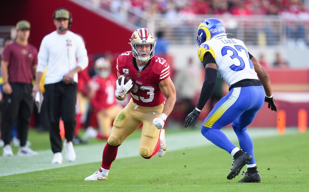 Nov 9, 2025; Santa Clara, California, USA; San Francisco 49ers running back Christian McCaffrey (23) runs the ball against Los Angeles Rams safety Quentin Lake (37) during the second quarter at Levi's Stadium. Mandatory Credit: Cary Edmondson-Imagn Images