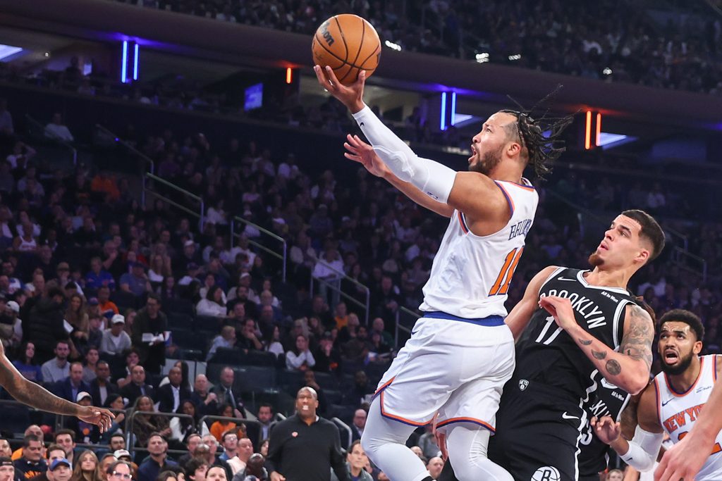 Nov 9, 2025; New York, New York, USA; New York Knicks guard Jalen Brunson (11) drives past Brooklyn Nets forward Michael Porter Jr. (17) in the first quarter at Madison Square Garden. Mandatory Credit: Wendell Cruz-Imagn Images