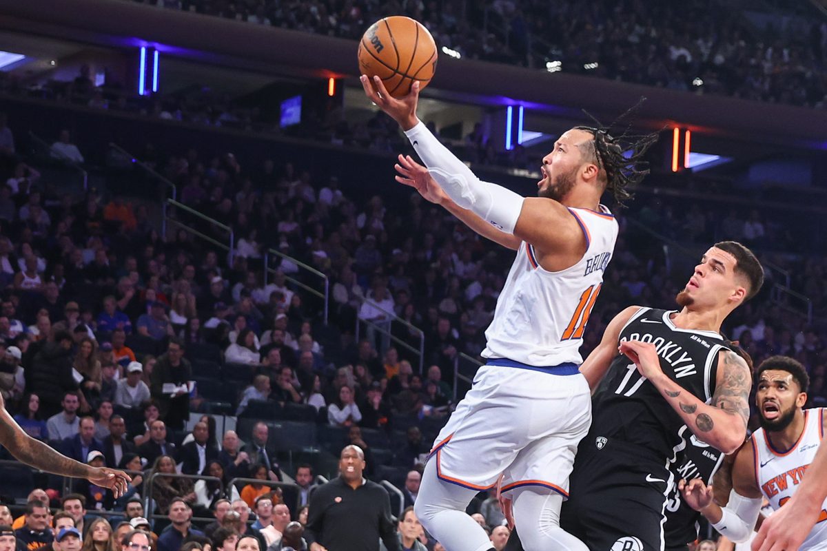 Nov 9, 2025; New York, New York, USA; New York Knicks guard Jalen Brunson (11) drives past Brooklyn Nets forward Michael Porter Jr. (17) in the first quarter at Madison Square Garden. Mandatory Credit: Wendell Cruz-Imagn Images