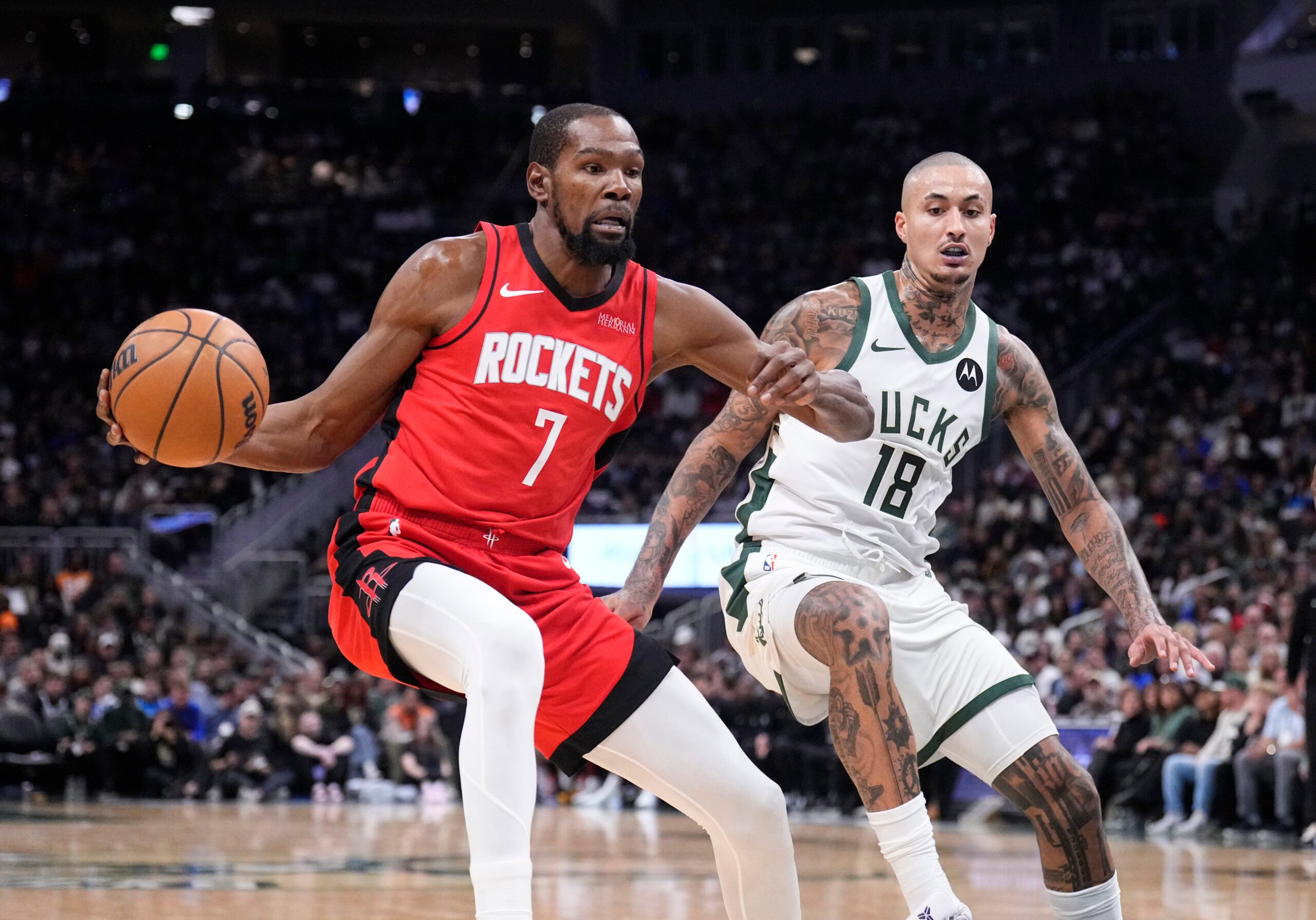 Nov 9, 2025; Milwaukee, Wisconsin, USA; Houston Rockets forward Kevin Durant (7) drives against Milwaukee Bucks forward Kyle Kuzma (18) in the first half at Fiserv Forum. Mandatory Credit: Michael McLoone-Imagn Images