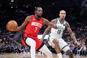 Nov 9, 2025; Milwaukee, Wisconsin, USA; Houston Rockets forward Kevin Durant (7) drives against Milwaukee Bucks forward Kyle Kuzma (18) in the first half at Fiserv Forum. Mandatory Credit: Michael McLoone-Imagn Images