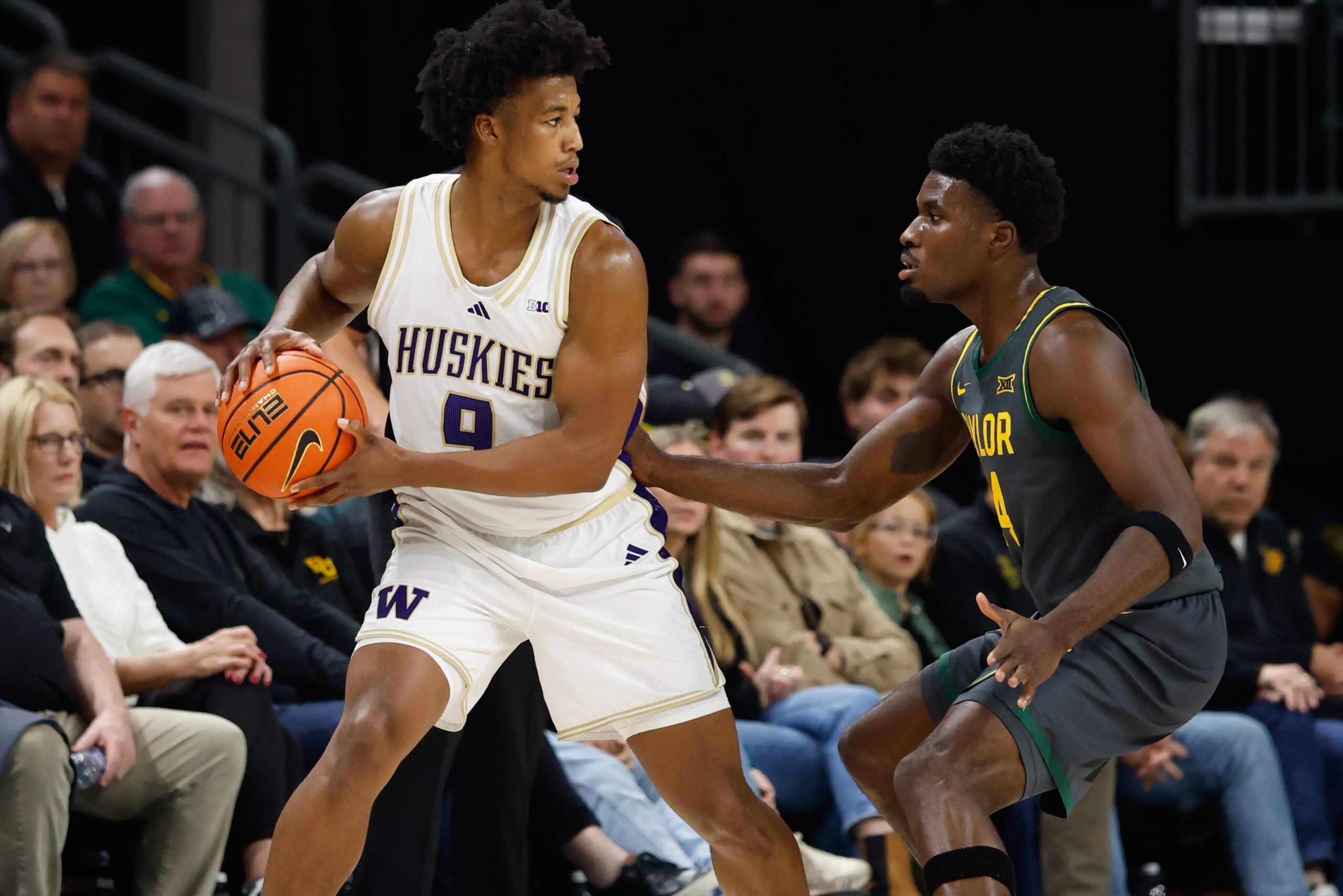Nov 9, 2025; Waco, Texas, USA;  Washington Huskies guard Wesley Yates III (9) controls the ball as Baylor Bears guard Tounde Yessoufou (24) defends during the first half at Paul and Alejandra Foster Pavilion. Mandatory Credit: Chris Jones-Imagn Images
