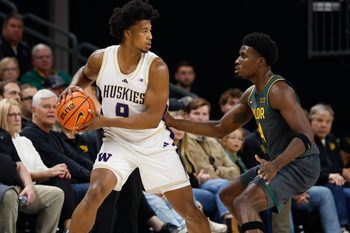 Nov 9, 2025; Waco, Texas, USA;  Washington Huskies guard Wesley Yates III (9) controls the ball as Baylor Bears guard Tounde Yessoufou (24) defends during the first half at Paul and Alejandra Foster Pavilion. Mandatory Credit: Chris Jones-Imagn Images