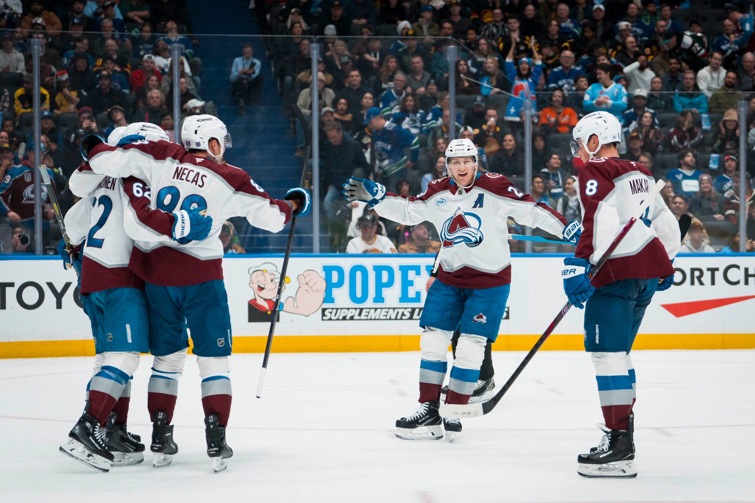 Nov 9, 2025; Vancouver, British Columbia, CAN; Colorado Avalanche forward Artturi Lehkonen (62) and forward Martin Necas (88) and forward Nathan MacKinnon (29) and defenseman Cale Makar (8) celebrate Lehkonen’s second gaol of the game against the Vancouver Canucks in the third period at Rogers Arena. Mandatory Credit: Bob Frid-Imagn Images