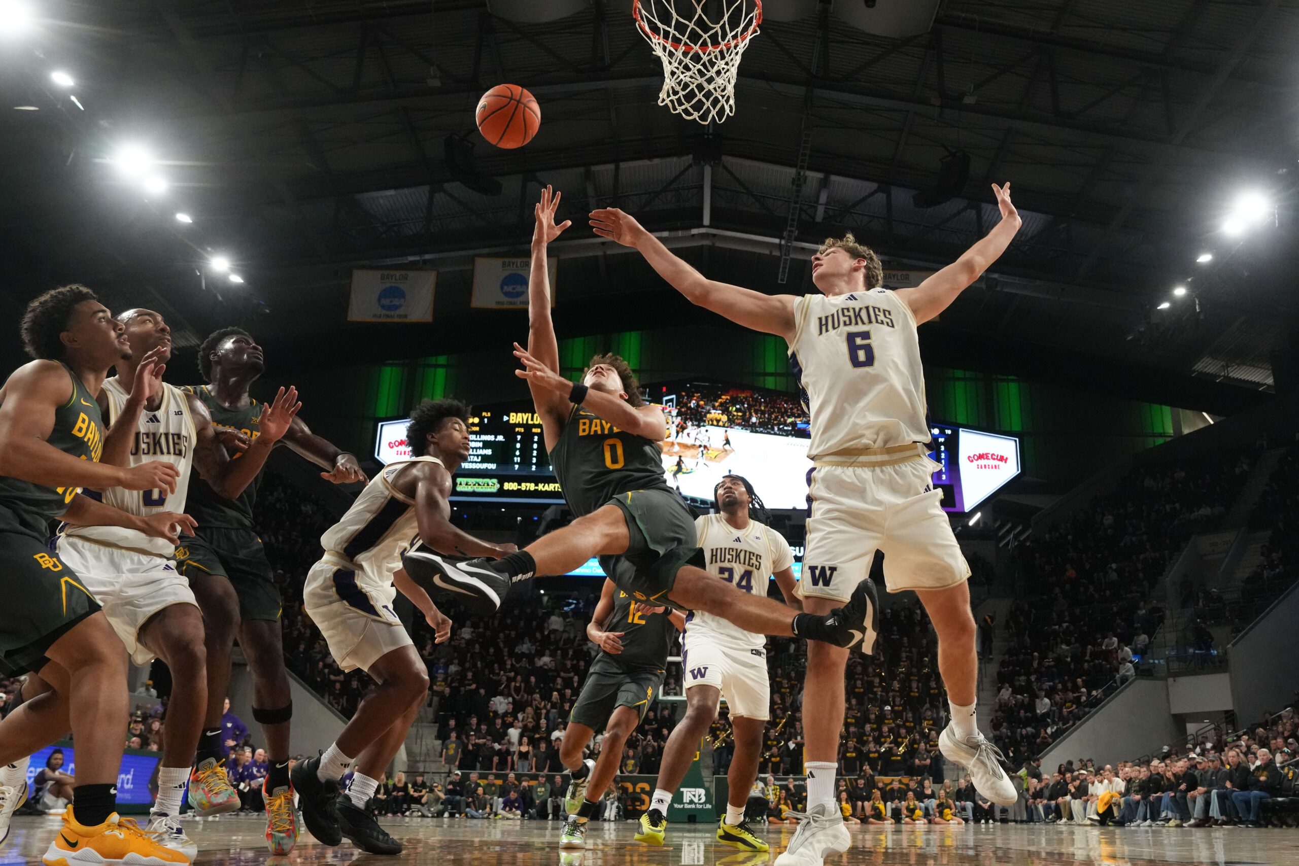 Nov 9, 2025; Waco, Texas, USA; Baylor Bears guard Dan Skillings Jr. (0) scores a layup against Washington Huskies forward Hannes Steinbach (6) during the second half at Paul and Alejandra Foster Pavilion. Mandatory Credit: Chris Jones-Imagn Images