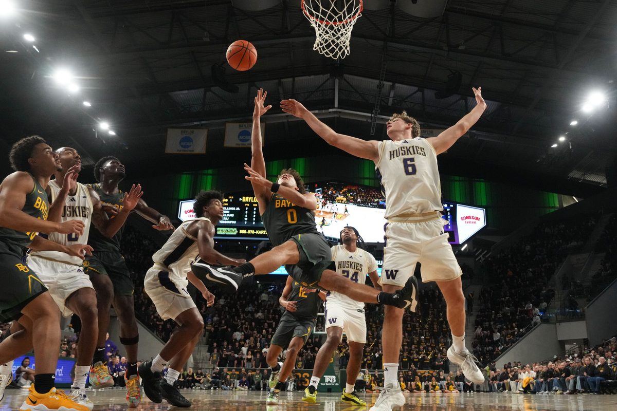 Nov 9, 2025; Waco, Texas, USA; Baylor Bears guard Dan Skillings Jr. (0) scores a layup against Washington Huskies forward Hannes Steinbach (6) during the second half at Paul and Alejandra Foster Pavilion. Mandatory Credit: Chris Jones-Imagn Images