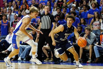 Nov 6, 2025; Gainesville, Florida, USA; North Florida Ospreys guard Kamrin Oriol (11) drives to the basket while Florida Gators forward Thomas Haugh (10) defends during the first half at Exactech Arena at the Stephen C. O'Connell Center. Mandatory Credit: Matt Pendleton-Imagn Images