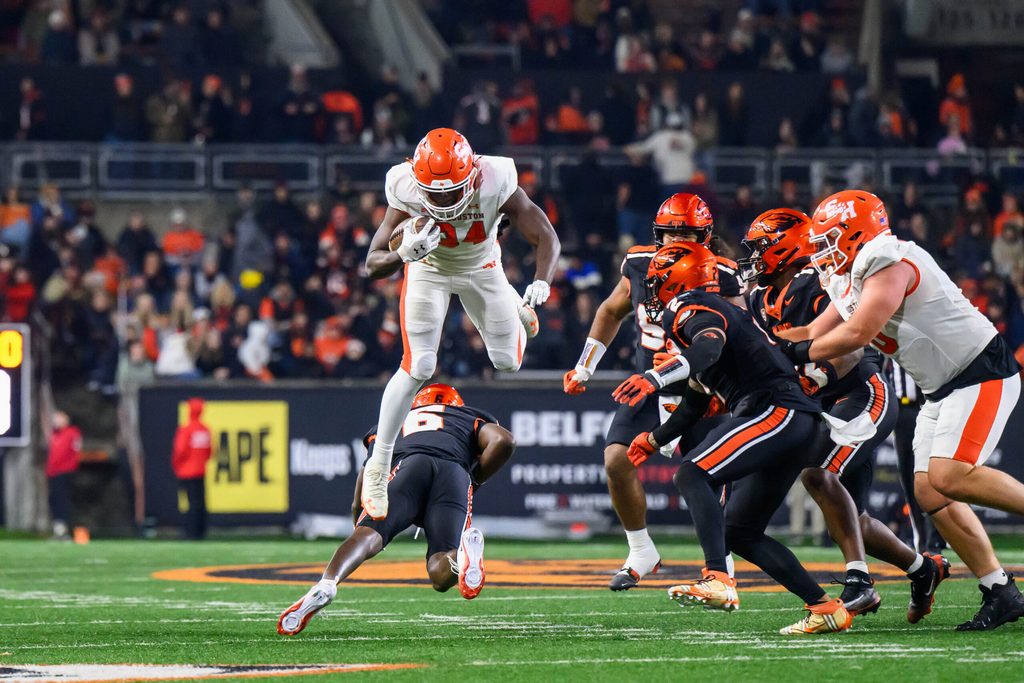Nov 8, 2025; Corvallis, Oregon, USA; Sam Houston Bearkats running back Landan Brown (34) hurdles Oregon State Beavers defensive back Jaheim Patterson (6) during the third quarter at Reser Stadium. Mandatory Credit: Craig Strobeck-Imagn Images
