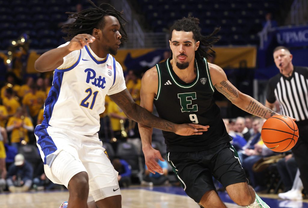 Nov 10, 2025; Pittsburgh, Pennsylvania, USA; Eastern Michigan Eagles forward Addison Patterson (9) dribbles the ball as Pittsburgh Panthers guard Macari Moore (21) defends during the first half at Petersen Events Center. Mandatory Credit: Charles LeClaire-Imagn Images