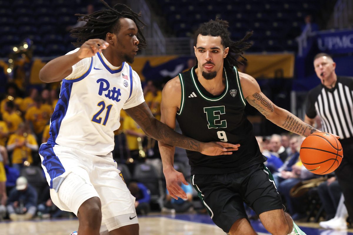 Nov 10, 2025; Pittsburgh, Pennsylvania, USA; Eastern Michigan Eagles forward Addison Patterson (9) dribbles the ball as Pittsburgh Panthers guard Macari Moore (21) defends during the first half at Petersen Events Center. Mandatory Credit: Charles LeClaire-Imagn Images