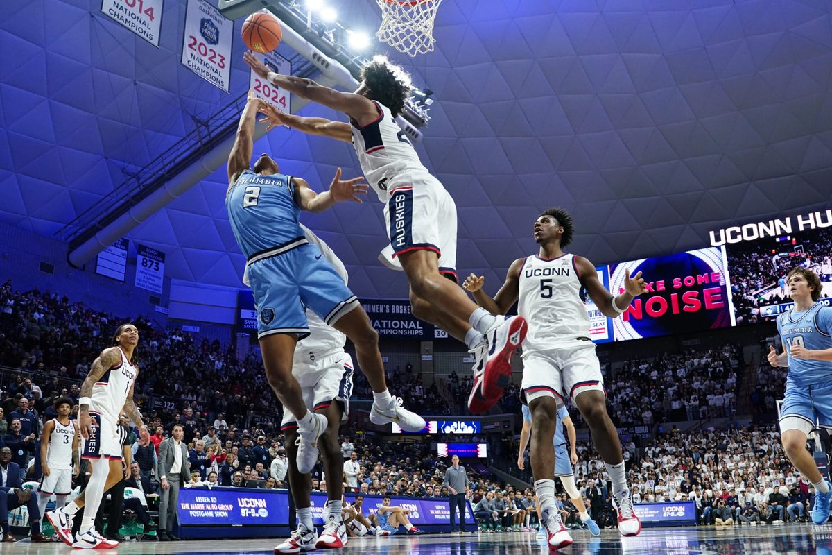 Nov 10, 2025; Storrs, Connecticut, USA; UConn Huskies forward Jayden Ross (23) defends against Columbia Lions guard Kenny Noland (2) in the first half at Harry A. Gampel Pavilion. Mandatory Credit: David Butler II-Imagn Images