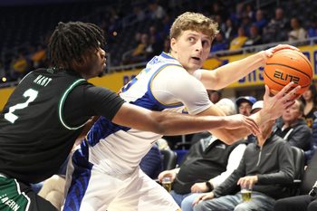 Nov 10, 2025; Pittsburgh, Pennsylvania, USA;  Eastern Michigan Eagles guard Carlos Hart (2) guards Pittsburgh Panthers guard Nojus Indrusaitis (25) during the second half at Petersen Events Center. Mandatory Credit: Charles LeClaire-Imagn Images