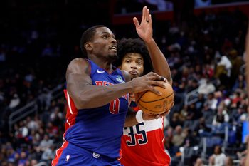 Nov 10, 2025; Detroit, Michigan, USA;  Detroit Pistons center Jalen Duren (0) dribbles defended by Washington Wizards forward Marvin Bagley III (35) in the second half at Little Caesars Arena. Mandatory Credit: Rick Osentoski-Imagn Images