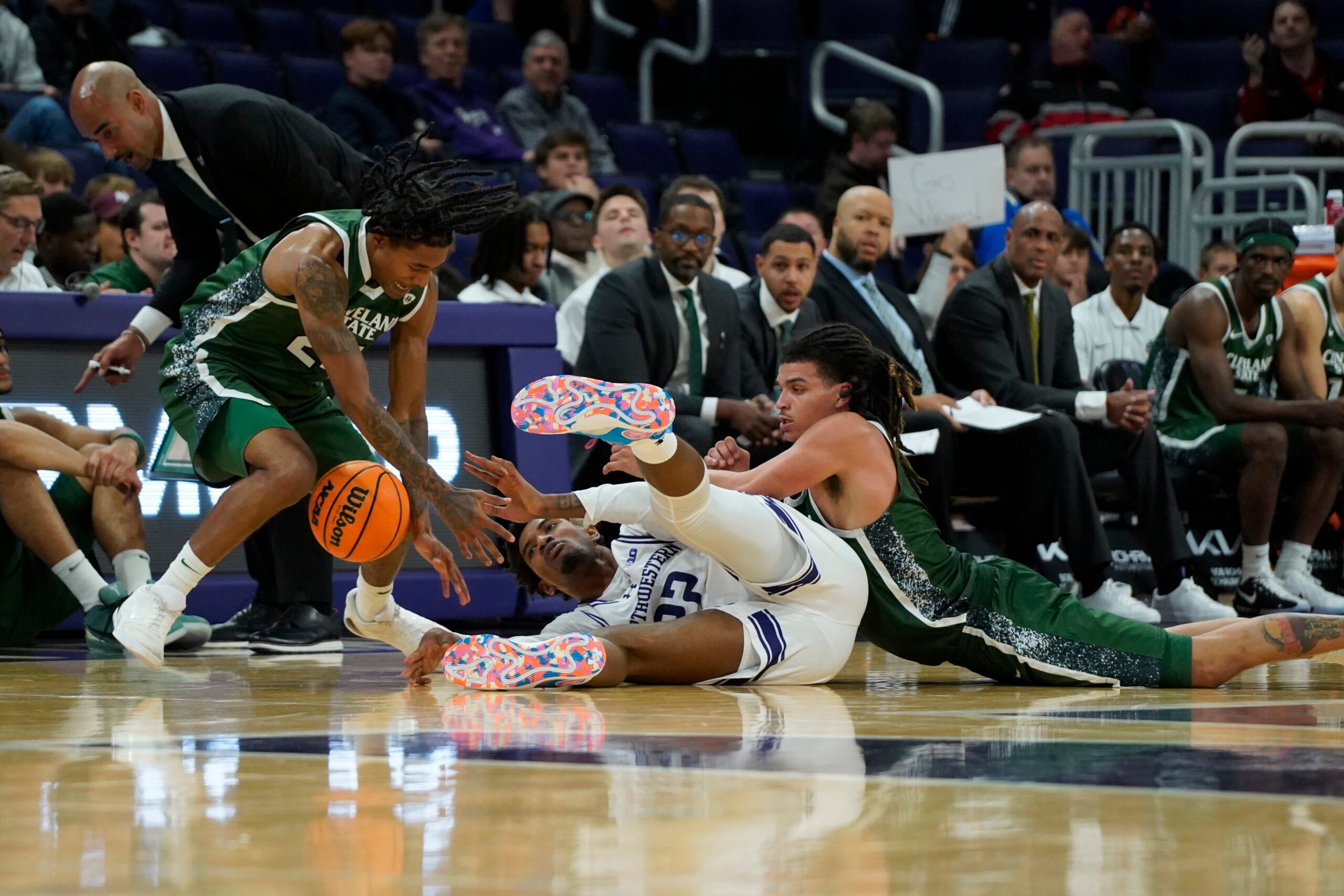 Nov 10, 2025; Evanston, Illinois, USA; Cleveland State Vikings guard Kamari Jones (24) forward Preist Ryan (4) and Northwestern Wildcats forward Arrinten Page (22) go for a loose ball during the second half at Welsh-Ryan Arena. Mandatory Credit: David Banks-Imagn Images