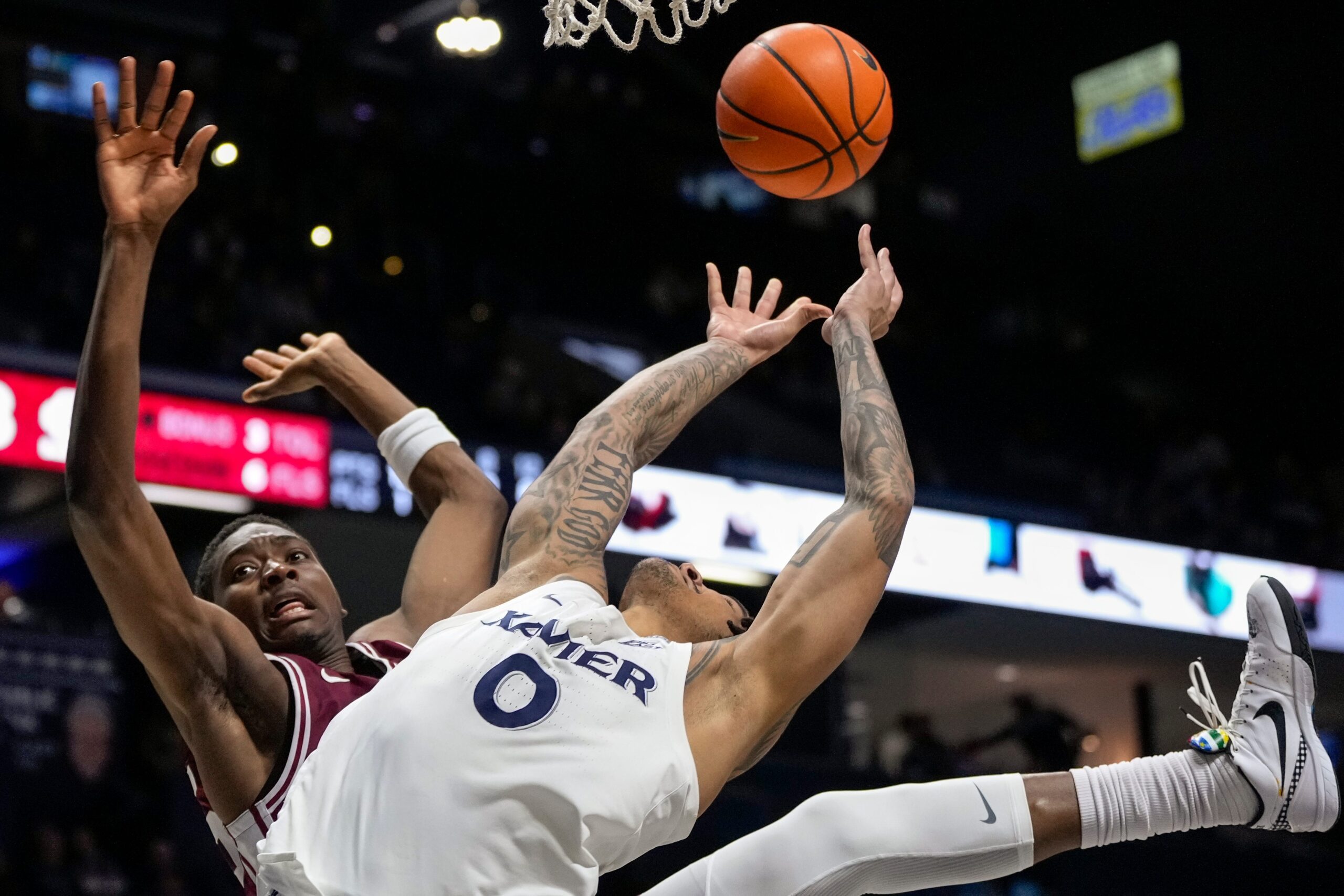 Santa Clara Broncos guard Thierry Darlan (15) and Xavier Musketeers guard Roddie Anderson III (0) collide under the basket in the second half of the NCAA Men’s Basketball game between the Xavier Musketeers and the Santa Clara Broncos at the Cintas Center in Cincinnati on Monday, Nov. 10, 2025. Xavier lost 87-68.