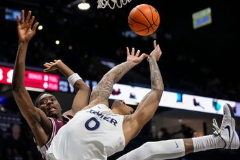 Santa Clara Broncos guard Thierry Darlan (15) and Xavier Musketeers guard Roddie Anderson III (0) collide under the basket in the second half of the NCAA Men’s Basketball game between the Xavier Musketeers and the Santa Clara Broncos at the Cintas Center in Cincinnati on Monday, Nov. 10, 2025. Xavier lost 87-68.