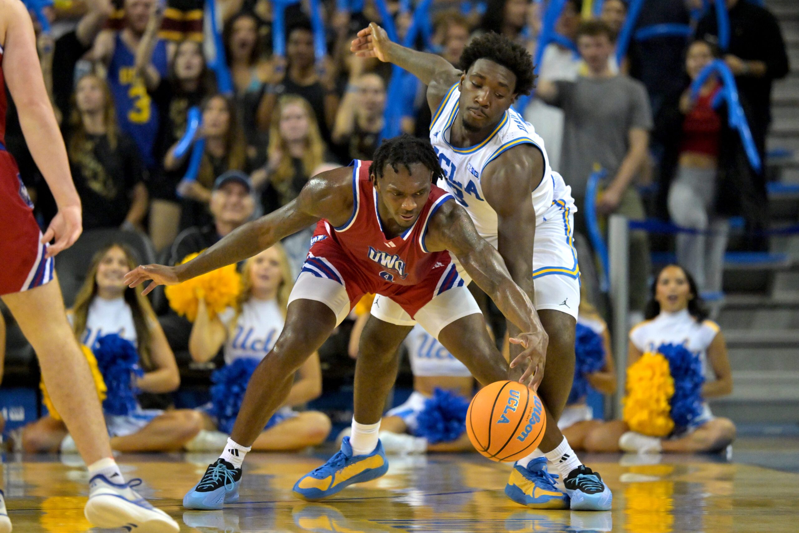 Nov 10, 2025; Los Angeles, California, USA; West Georgia Wolves forward Shelton Williams-Dryden (4) keeps the ball from UCLA Bruins forward Eric Dailey Jr. (3) during the second half at Pauley Pavilion presented by Wescom Financial. Mandatory Credit: Jayne Kamin-Oncea-Imagn Images